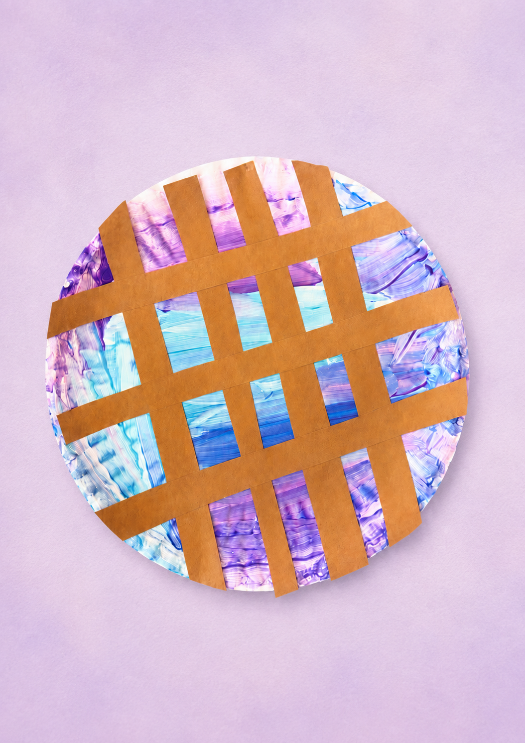 Preschool paper plate blueberry pie craft with purple and blue paint under a brown paper lattice crust